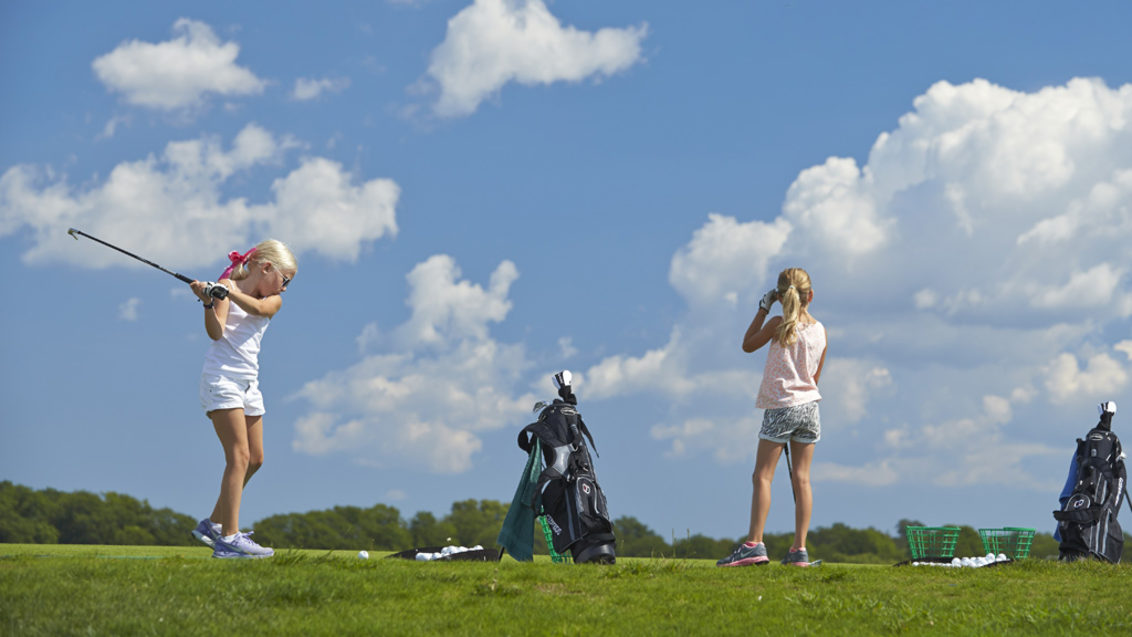Young girl golfers playing